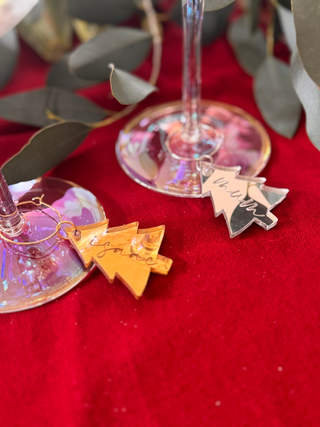 Decorative charms on a wine glass with a red background